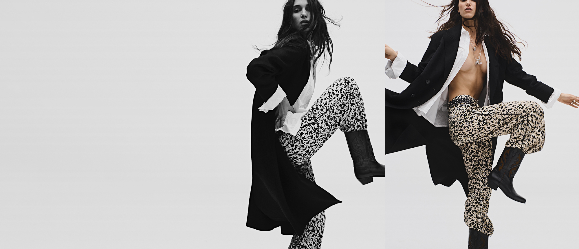 Ablonde model wearing a black coat and fluid printed trousers, with santiag boots